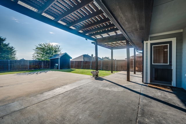 view of patio with a pergola and a storage shed