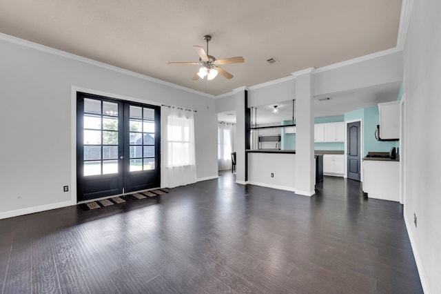 unfurnished living room with french doors, dark hardwood / wood-style floors, ornamental molding, and ceiling fan