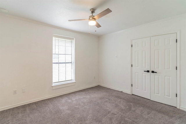 unfurnished room featuring ornamental molding, light colored carpet, and ceiling fan