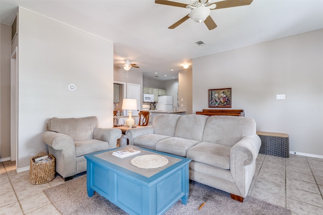 tiled living room with ceiling fan