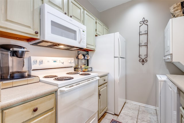 kitchen featuring white appliances and light tile patterned flooring