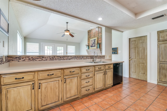 kitchen with a textured ceiling, lofted ceiling, dishwasher, ceiling fan, and sink