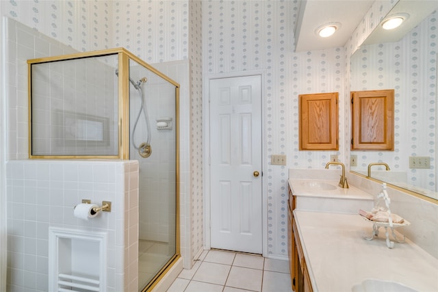 bathroom with double sink vanity, an enclosed shower, and tile patterned flooring