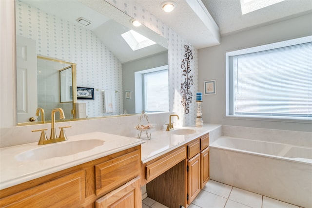 bathroom featuring a textured ceiling, a bathtub, dual vanity, tile patterned floors, and lofted ceiling with skylight