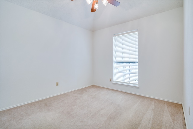 unfurnished room with ceiling fan and light carpet