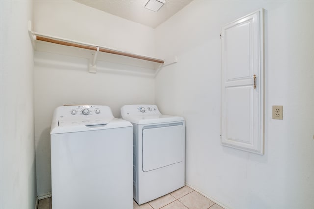 laundry room with light tile patterned floors and washer and dryer