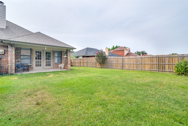 view of yard featuring french doors and a patio