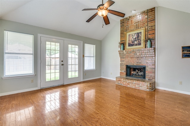 unfurnished living room with ceiling fan, light wood-type flooring, french doors, and vaulted ceiling