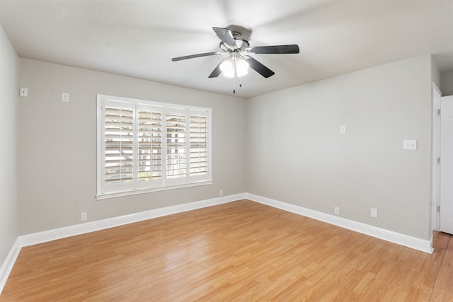 empty room with ceiling fan and light hardwood / wood-style floors