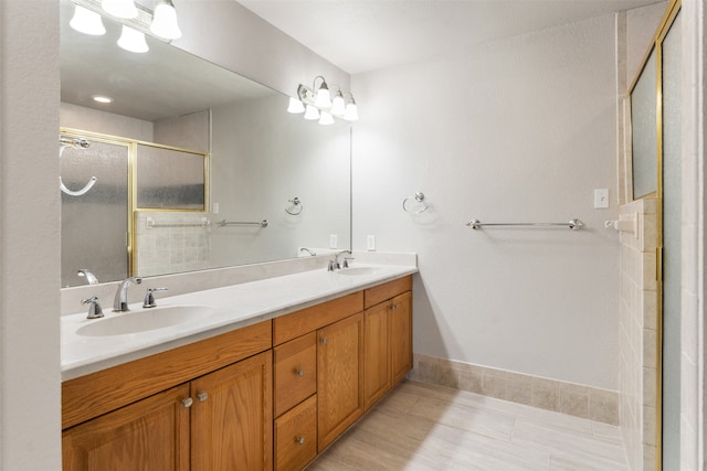 bathroom featuring double vanity, tile patterned floors, and a shower with shower door