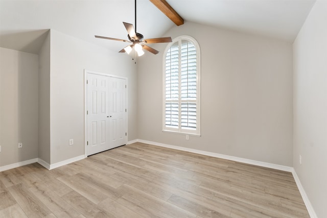 unfurnished bedroom with ceiling fan, light hardwood / wood-style flooring, lofted ceiling with beams, and multiple windows