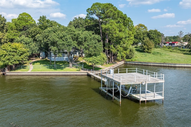 view of dock featuring a water view and a yard