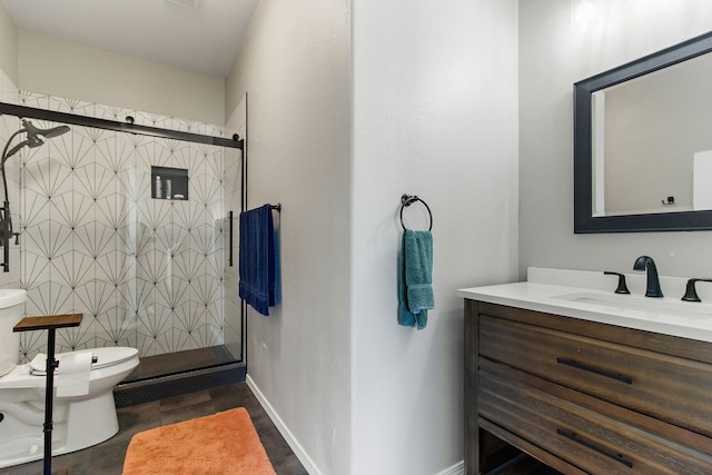 bathroom with vanity, toilet, and an enclosed shower