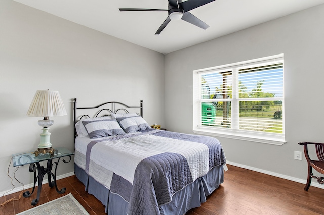 bedroom featuring ceiling fan and dark hardwood / wood-style floors