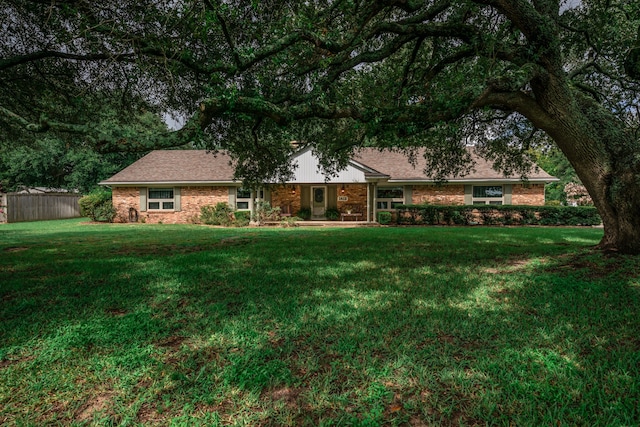 ranch-style home with a front lawn