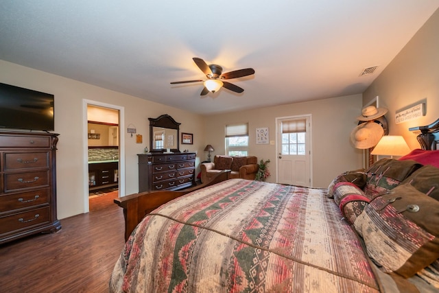 bedroom with visible vents, a ceiling fan, dark wood finished floors, and ensuite bathroom