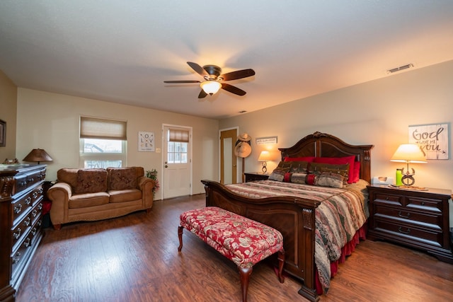 bedroom with a ceiling fan, wood finished floors, and visible vents