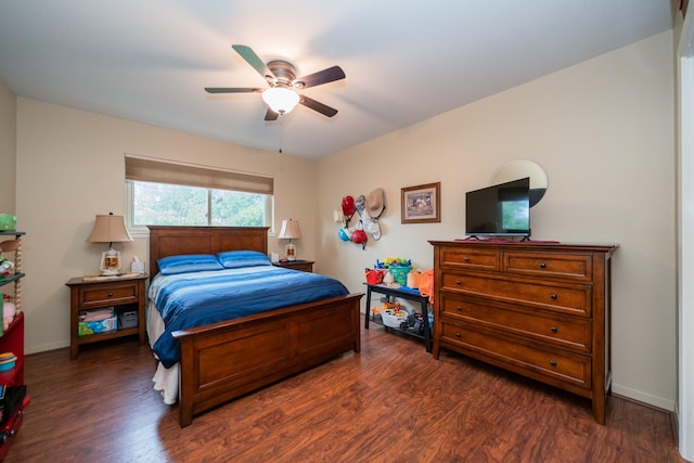 bedroom featuring baseboards, a ceiling fan, and dark wood-type flooring