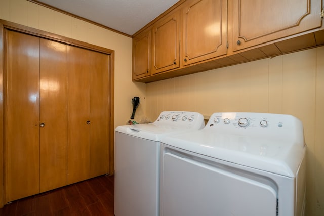 laundry room with independent washer and dryer, dark hardwood / wood-style floors, and cabinets