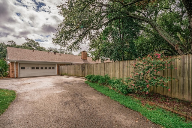 exterior space with fence and aphalt driveway