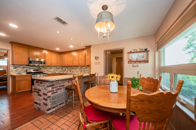 dining space featuring a notable chandelier and hardwood / wood-style flooring