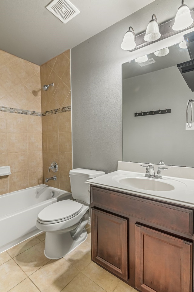 bathroom featuring tile patterned floors, visible vents, toilet, washtub / shower combination, and vanity