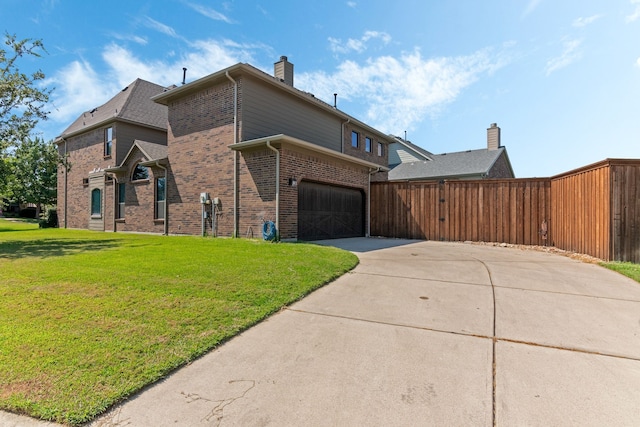 view of home's exterior featuring a yard, fence, brick siding, and driveway