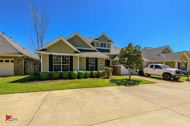 view of front of house with a garage and a front lawn