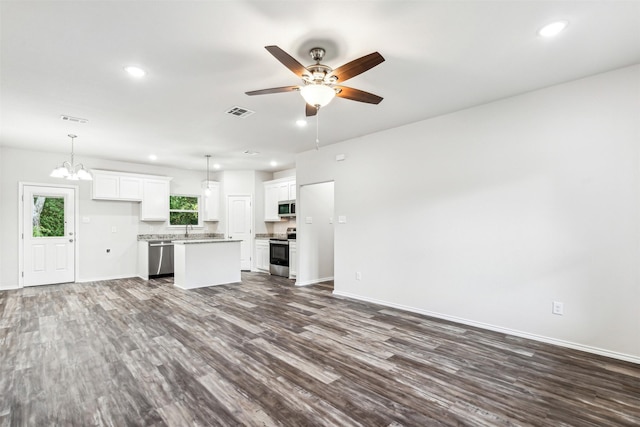 kitchen featuring dark wood-type flooring, white cabinets, hanging light fixtures, a kitchen island, and stainless steel appliances