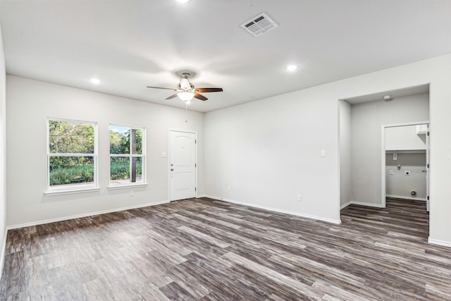 unfurnished room with ceiling fan and dark wood-type flooring