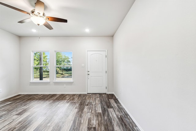 spare room with ceiling fan and dark hardwood / wood-style floors