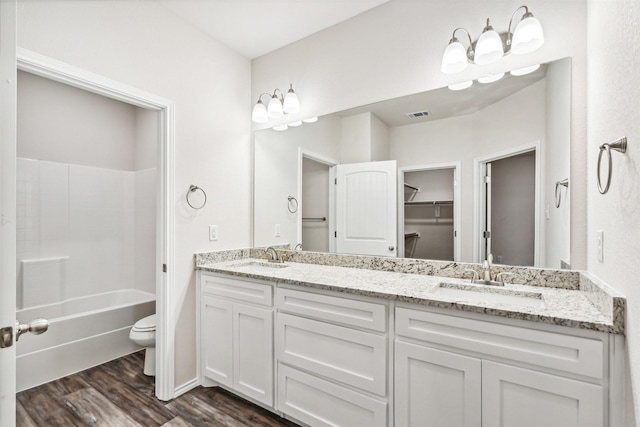 full bathroom with toilet, vanity, shower / bathtub combination, and hardwood / wood-style flooring