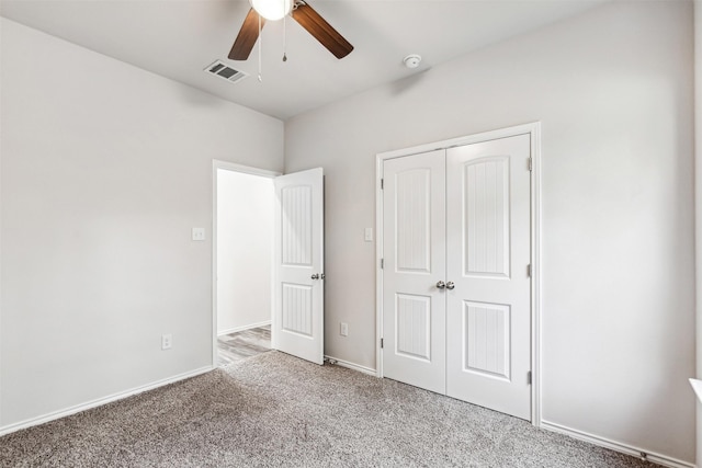 unfurnished bedroom featuring ceiling fan, a closet, and light colored carpet