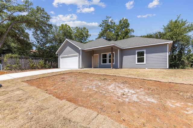 single story home featuring concrete driveway, roof with shingles, an attached garage, and fence