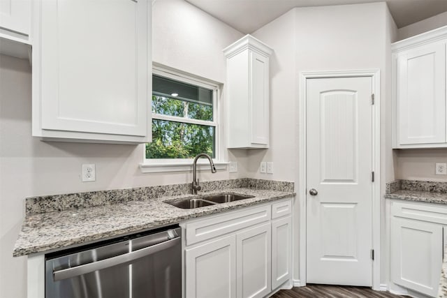 kitchen with white cabinets, dark hardwood / wood-style flooring, stainless steel dishwasher, and sink