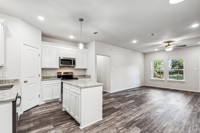 kitchen featuring hanging light fixtures, appliances with stainless steel finishes, white cabinetry, and ceiling fan