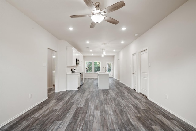 unfurnished living room featuring ceiling fan, baseboards, dark wood finished floors, and recessed lighting