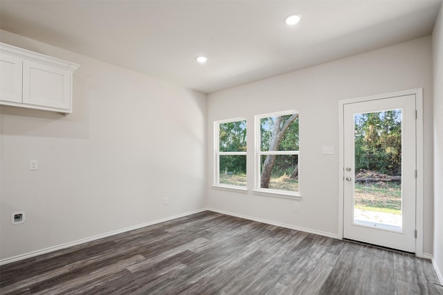 interior space featuring baseboards, dark wood-type flooring, and recessed lighting