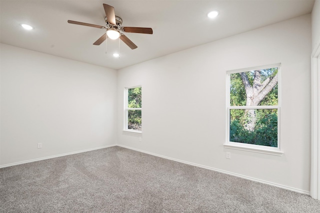 carpeted spare room featuring ceiling fan, baseboards, and recessed lighting