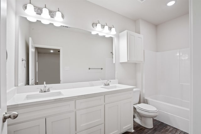 full bathroom featuring visible vents, wood finished floors, a sink, and toilet