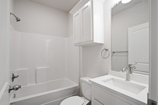 bathroom featuring washtub / shower combination, vanity, and toilet