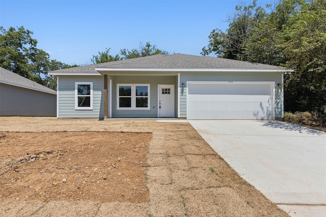 ranch-style home featuring a garage and driveway