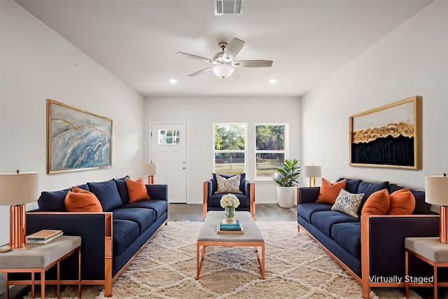 living room with hardwood / wood-style floors and ceiling fan