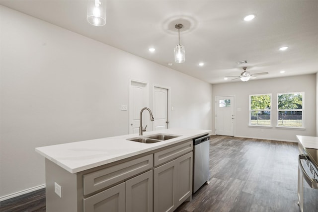 kitchen with a sink, stainless steel dishwasher, gray cabinets, an island with sink, and decorative light fixtures