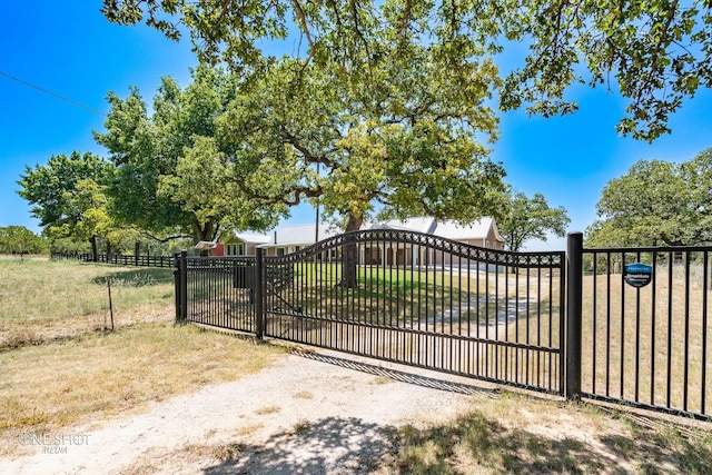 view of gate featuring a yard