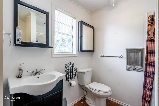 bathroom featuring a healthy amount of sunlight, ornamental molding, vanity, and toilet