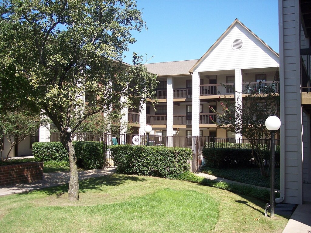 view of front of home featuring a front yard and a balcony