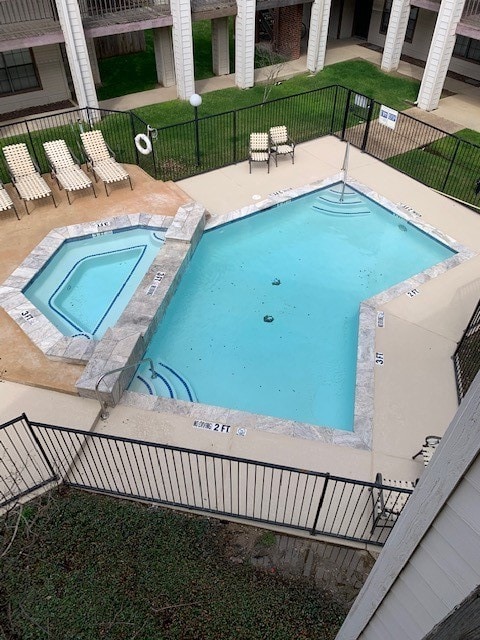 view of pool featuring a hot tub and a patio