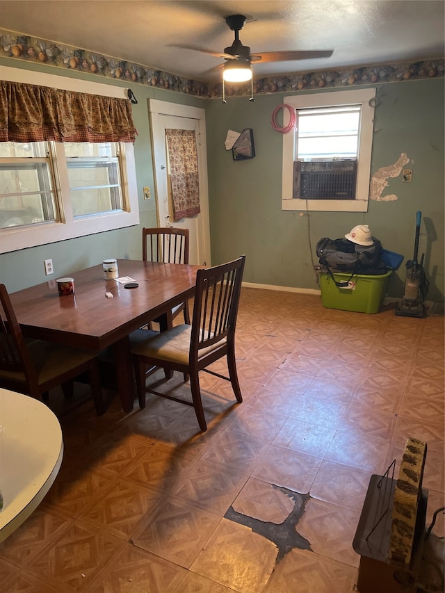 dining room featuring a textured ceiling, cooling unit, and ceiling fan