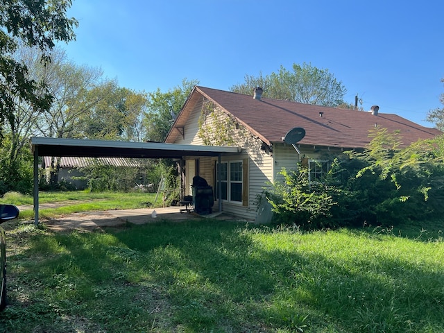 back of property with a patio and a yard